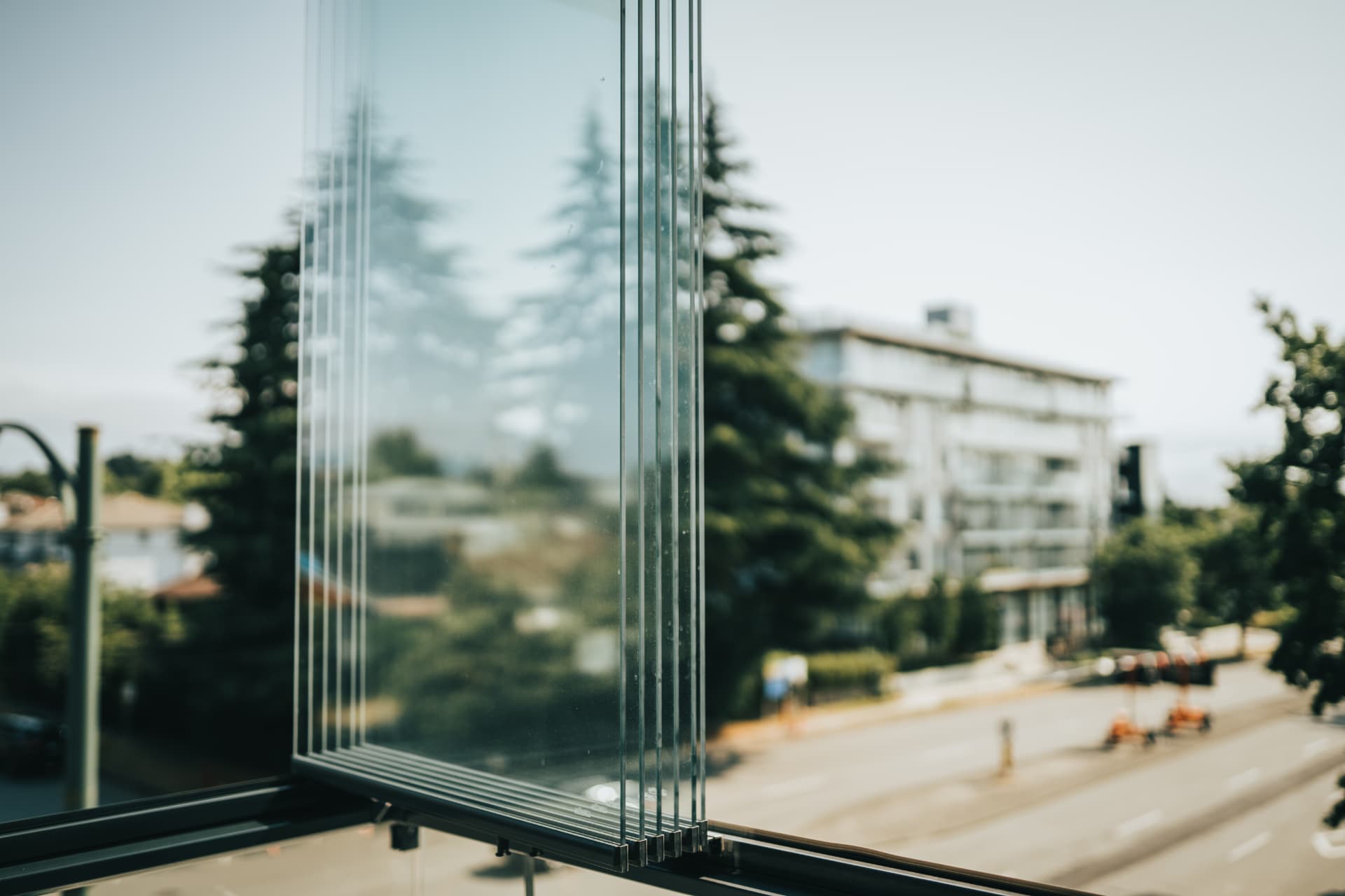Close-up of retractable glass panels stacked open on a balcony