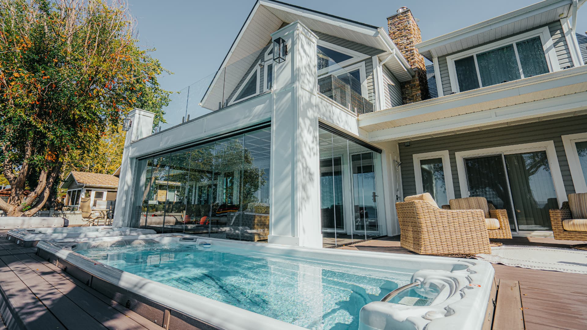 Full elevation of the lake house with glass room and upper glass balcony railing