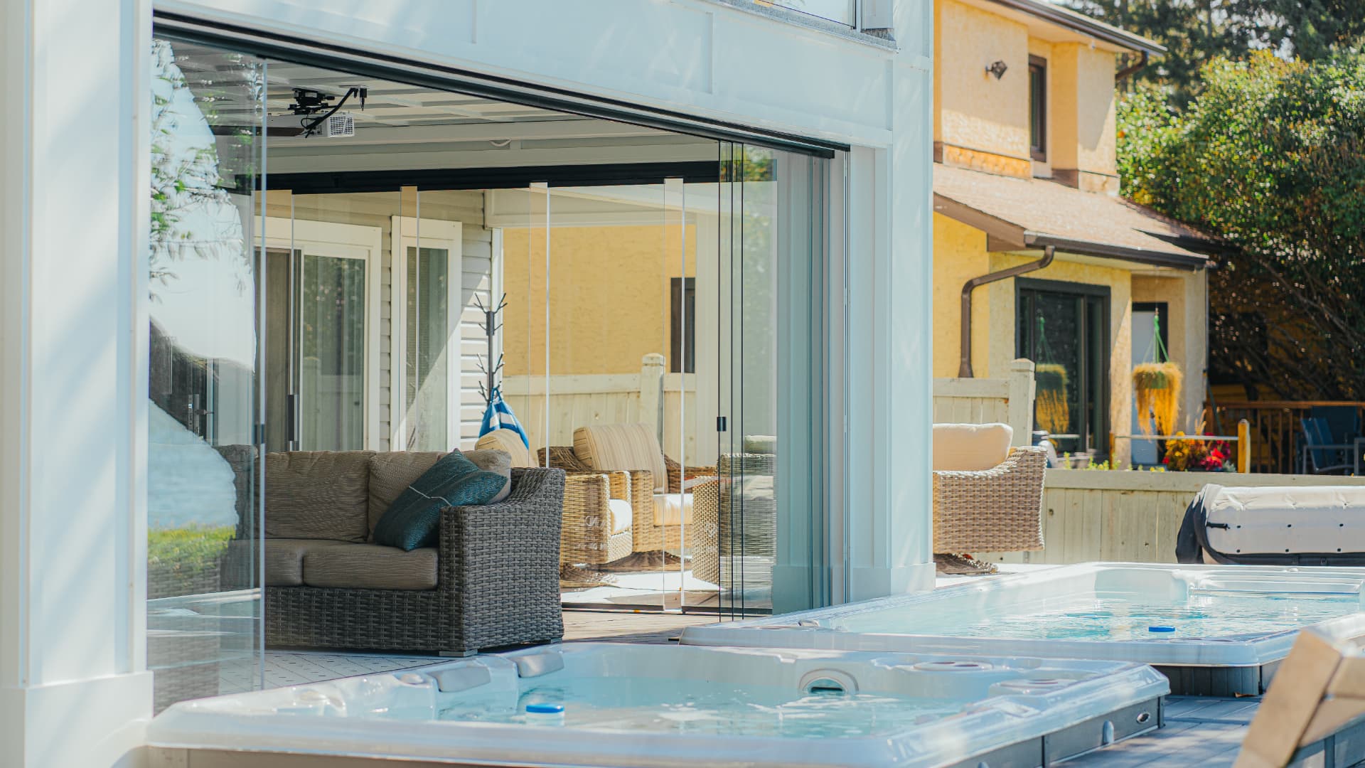Glass room seen across the swim spa with panels fully retracted