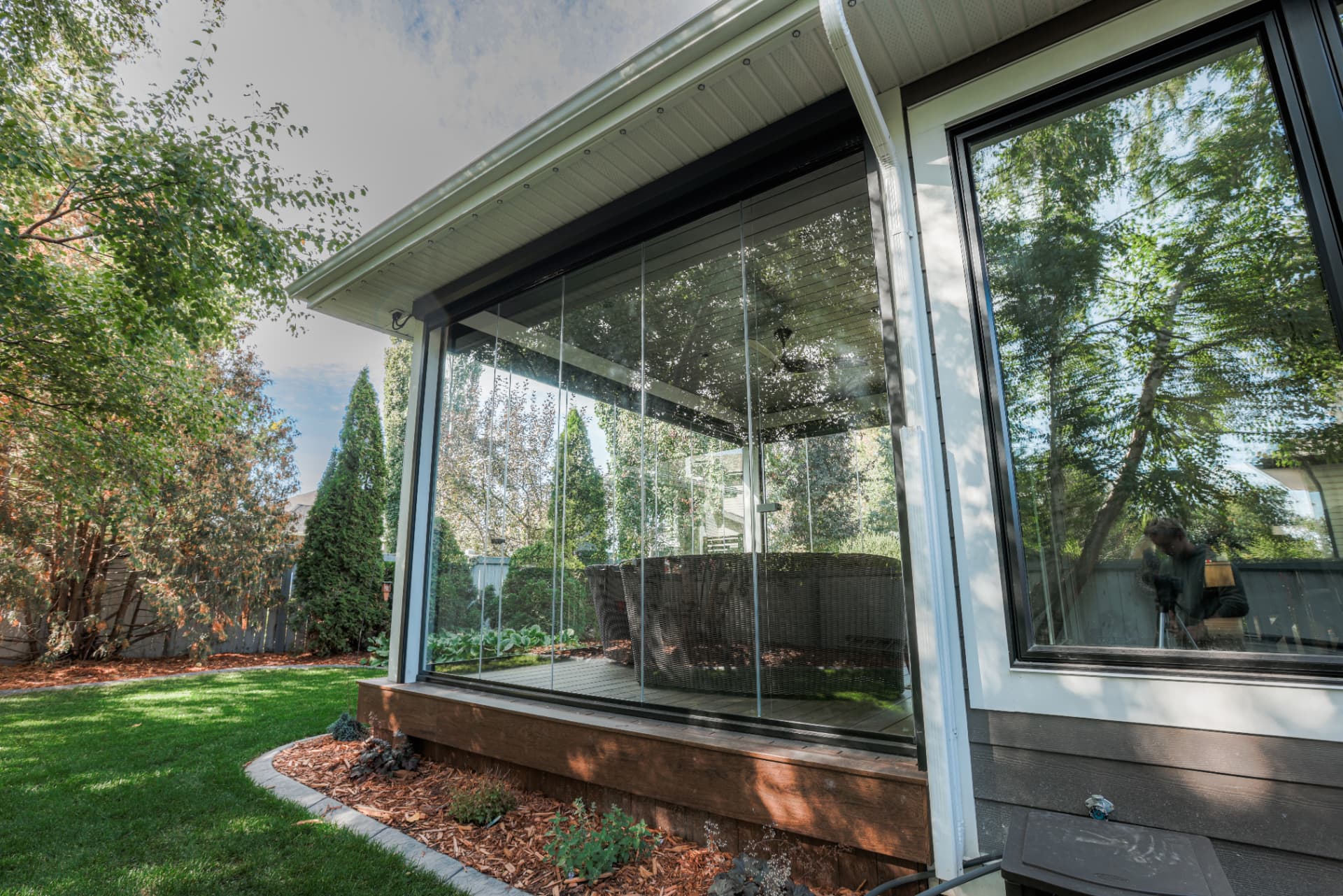 Side view of the enclosure showing the full run of frameless glass panels
