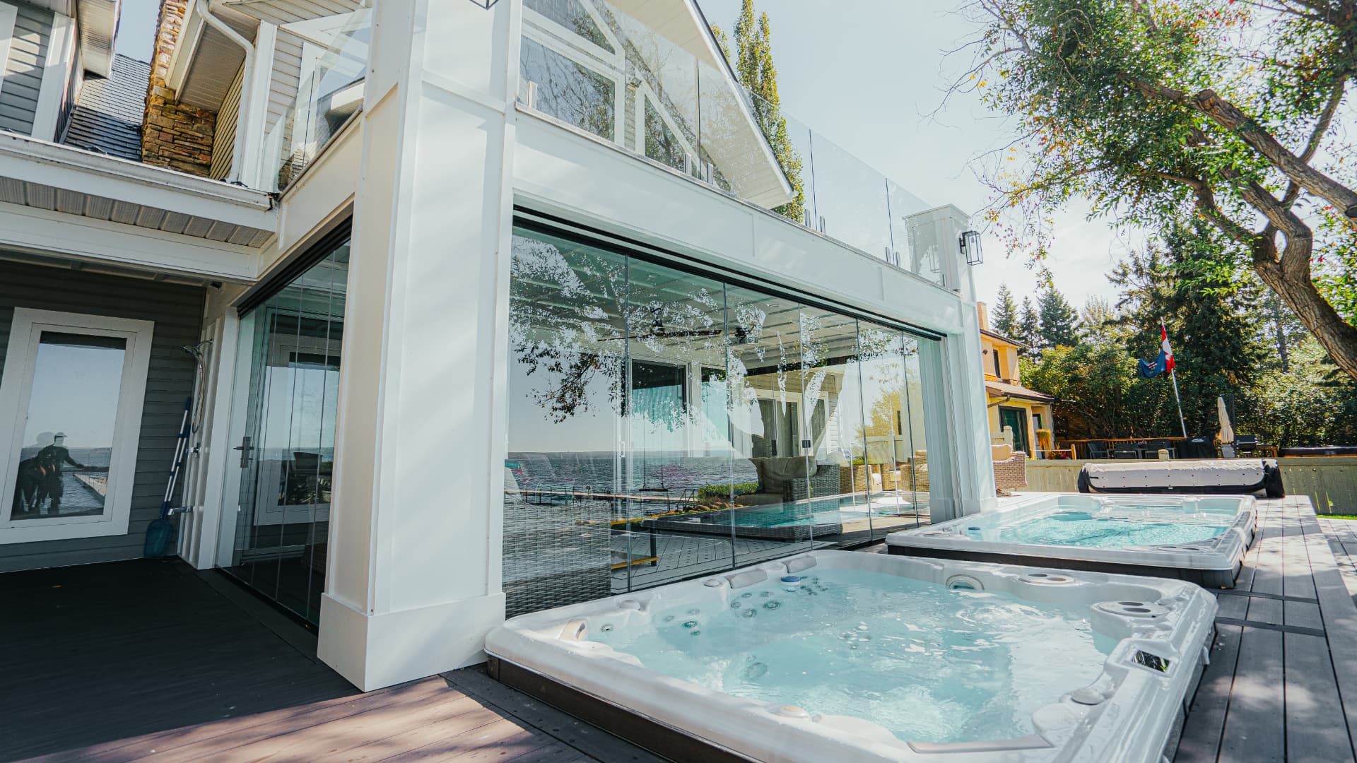 Exterior of the glass room with swim spas on the composite deck
