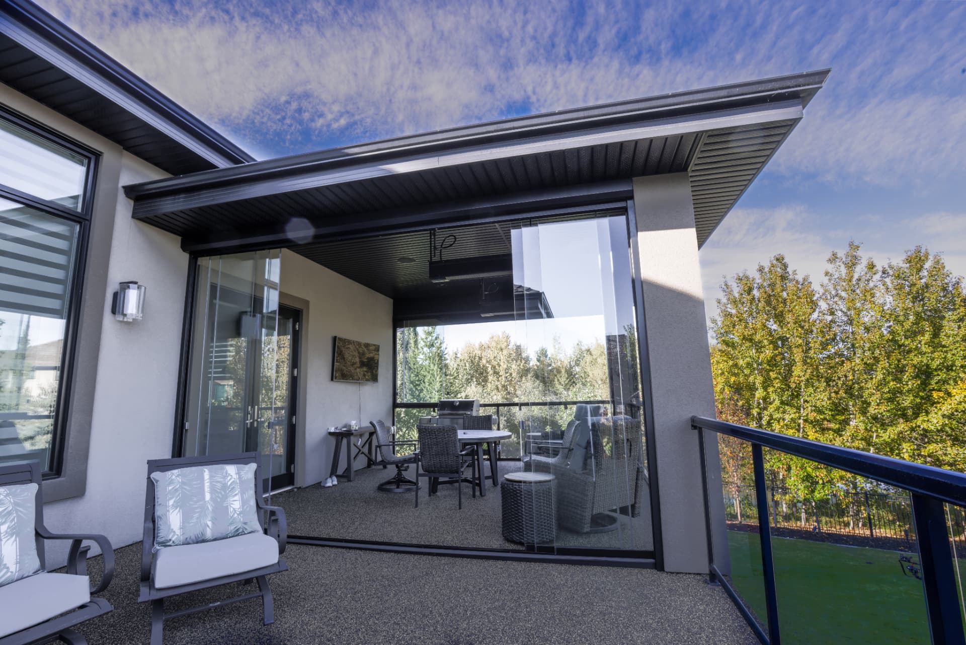 Balcony room seen from the open deck with glass walls partly retracted