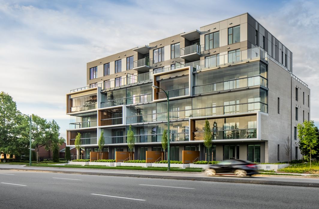 Wide elevation of the building showing glazed balconies across all floors